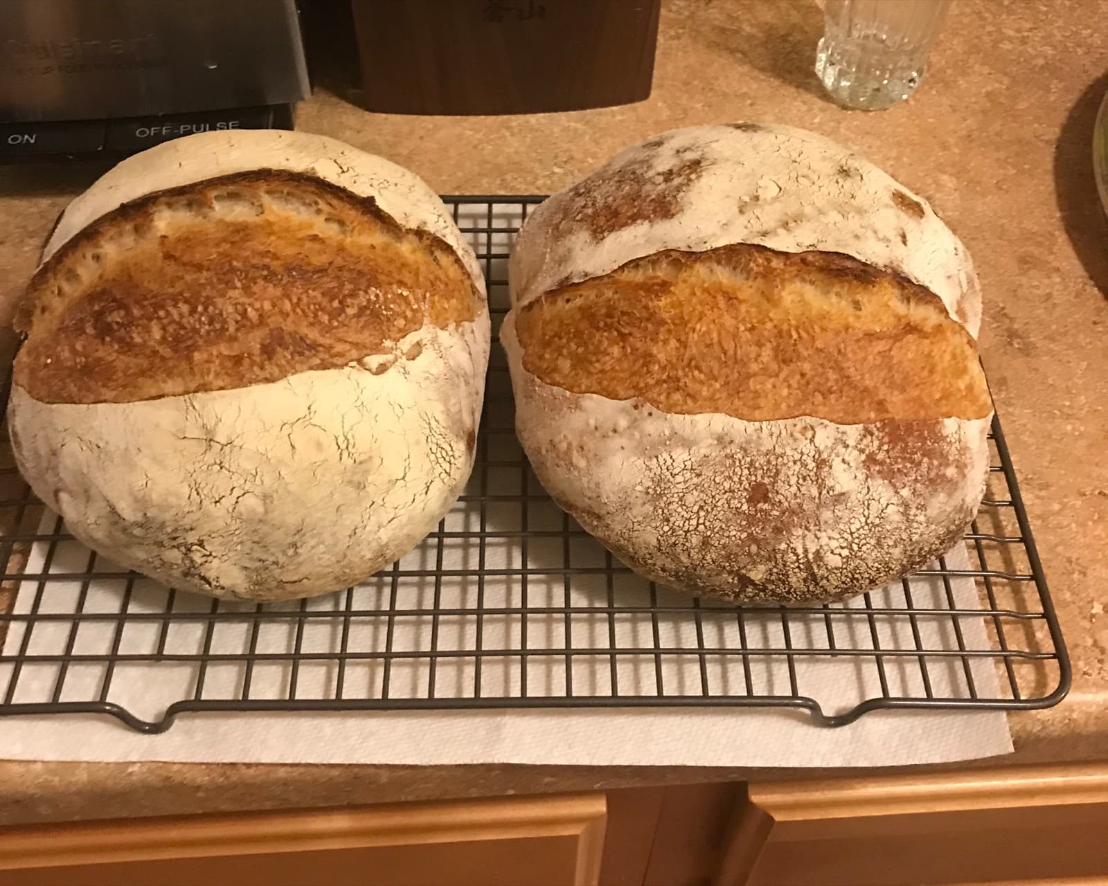 Two round sourdough boules cooling on a rack, my first loaves from December 2018.